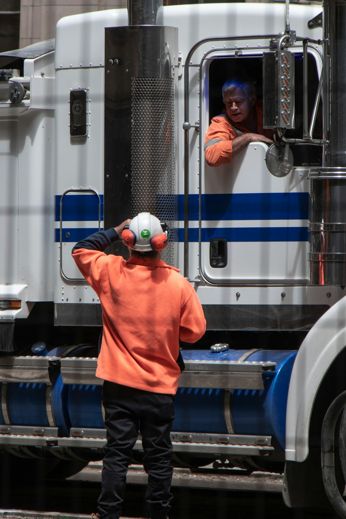 An owner-operator standing beside his tractor unit